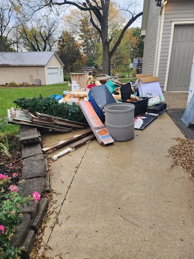 Dumpster being loaded with debris for Estate Cleanout Dumpster Rental in Camano